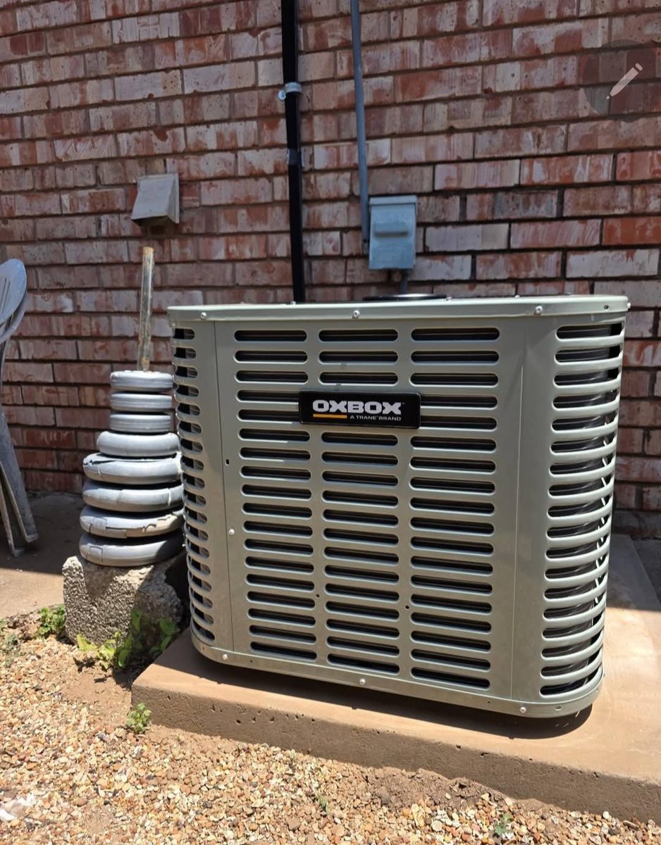 HVAC technician checking refrigerant pressures with digital gauges on a mini-split condenser