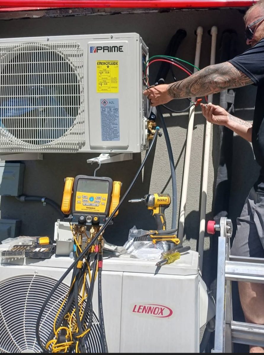 Oxbox by Trane outdoor condenser unit installed on a concrete pad against a brick wall