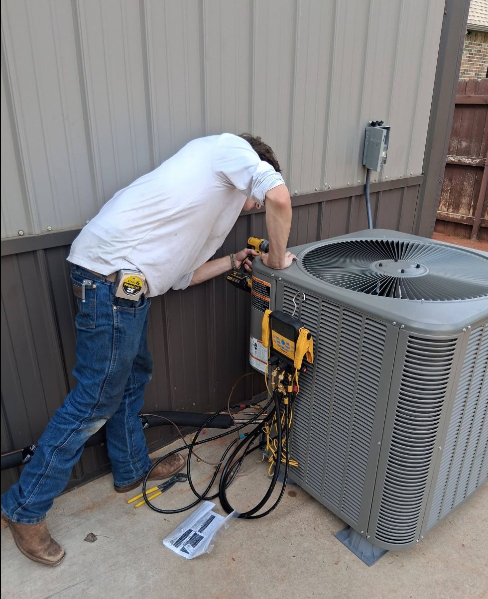 Residential AC service technician diagnosing an outdoor condenser